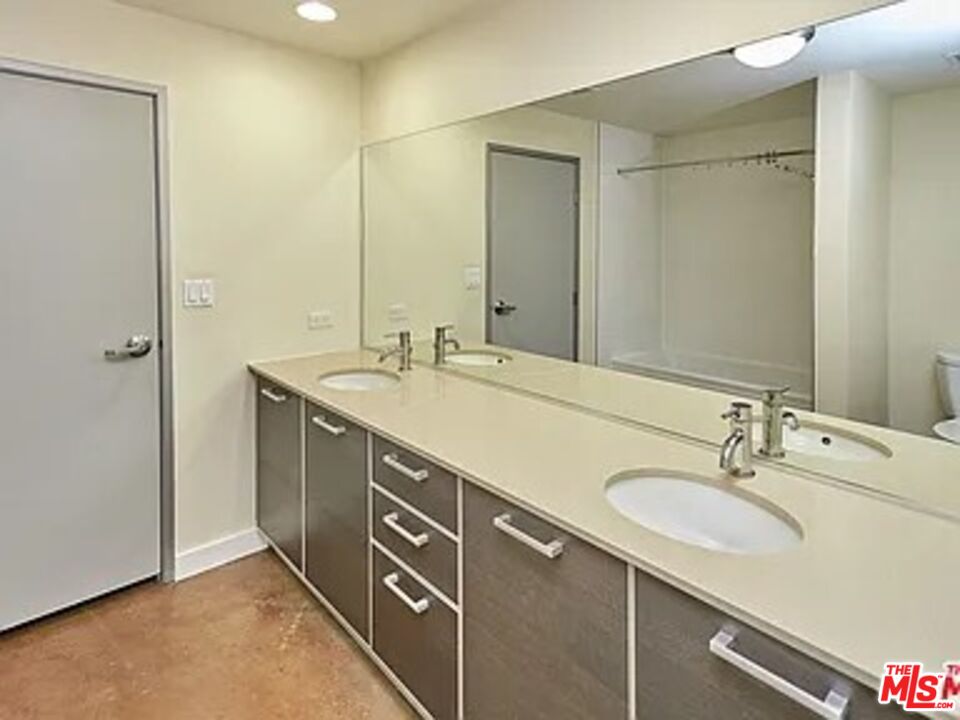 645 West 9th Street, Unit 240 Los Angeles, CA 90015 - Photo 25 of 25 a bathroom with a sink double vanity and a mirror