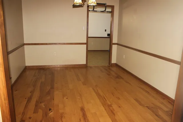 a view of a room with wooden floor