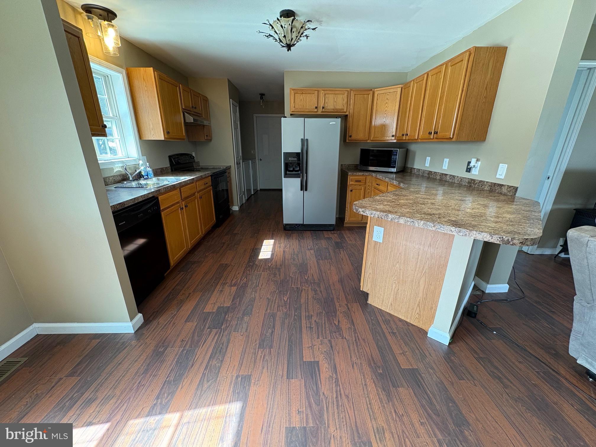 514 Kidney Road Genesee, PA 16923 - Photo 12 of 84 a kitchen with granite countertop wooden floors and a sink