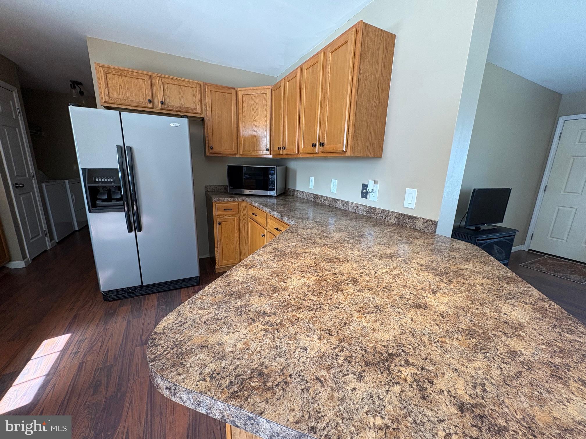 514 Kidney Road Genesee, PA 16923 - Photo 15 of 84 a kitchen with granite countertop a refrigerator a sink a stove a microwave and wooden floor