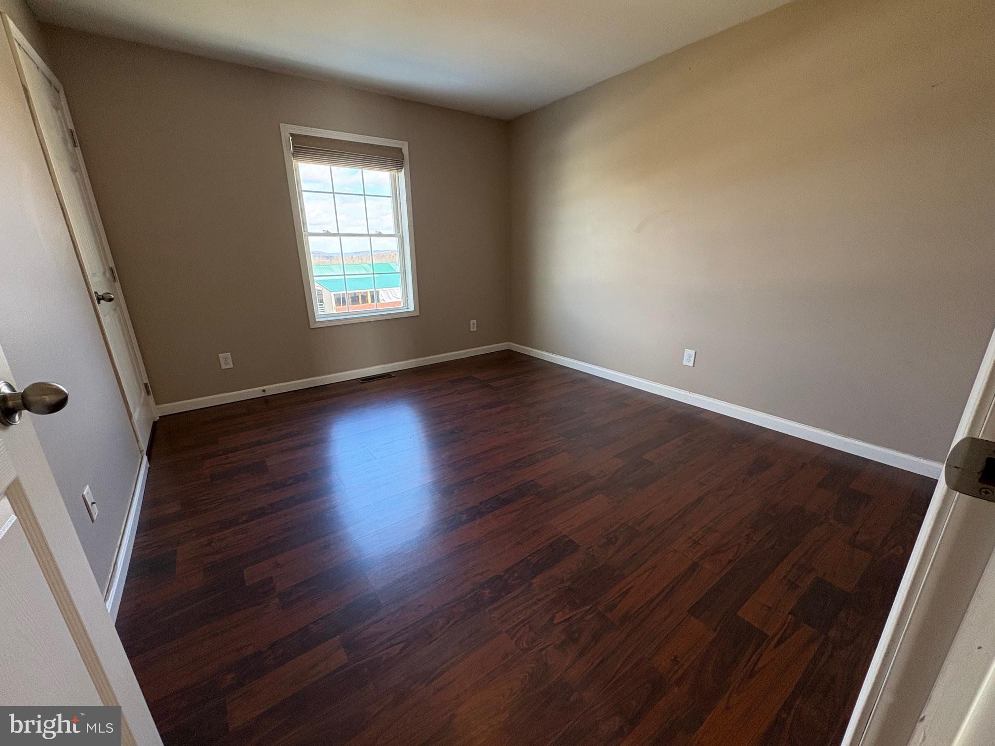 514 Kidney Road Genesee, PA 16923 - Photo 30 of 84 an empty room with wooden floor and windows