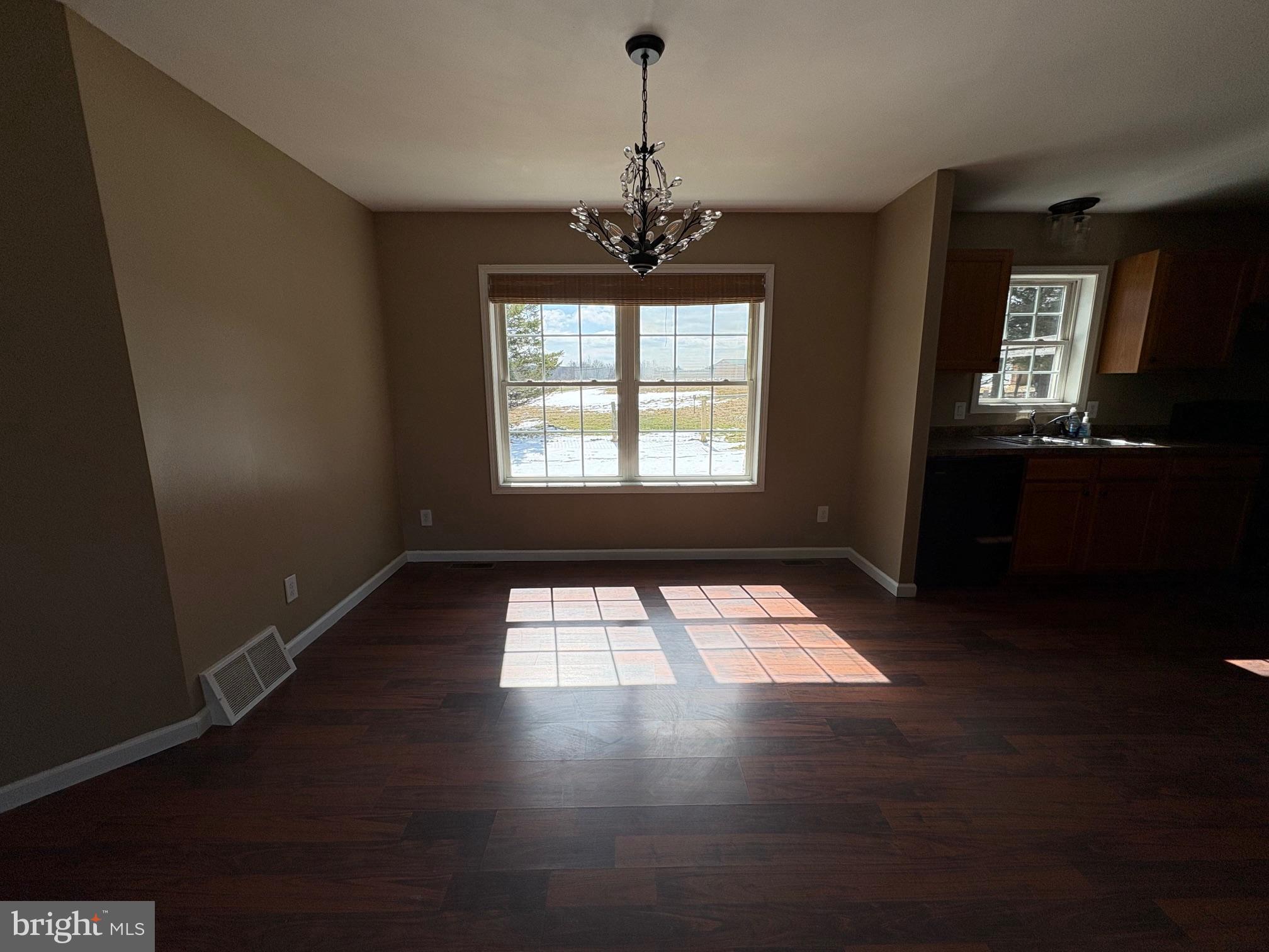 514 Kidney Road Genesee, PA 16923 - Photo 10 of 84 a view of an empty room with wooden floor and a window