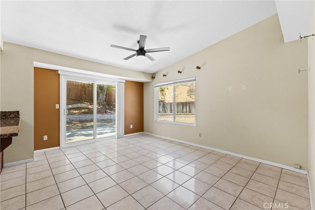 12011 Quantico Drive Riverside, CA 92505 - Photo 16 of 75 a view of an empty room with window and chandelier fan