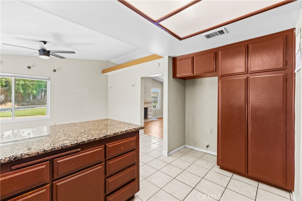 12011 Quantico Drive Riverside, CA 92505 - Photo 24 of 75 a kitchen with stainless steel appliances granite countertop a refrigerator and a sink