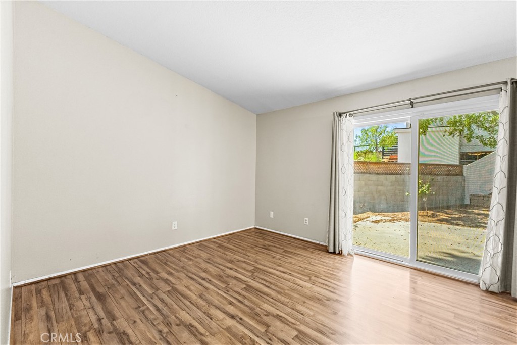12011 Quantico Drive Riverside, CA 92505 - Photo 31 of 75 an empty room with wooden floor and windows