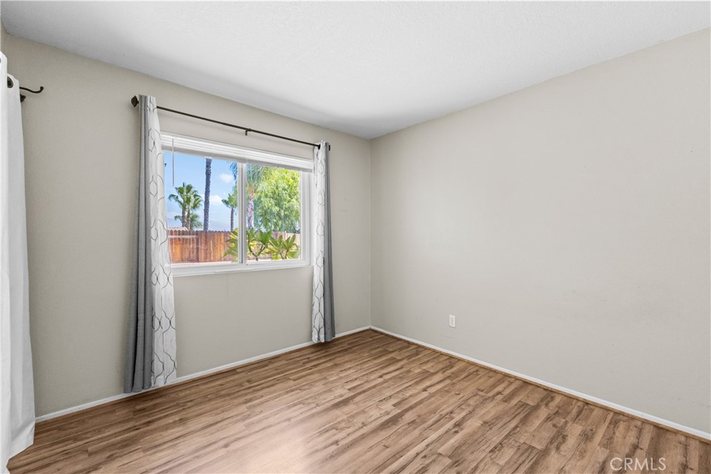 12011 Quantico Drive Riverside, CA 92505 - Photo 39 of 75 a view of empty room with wooden floor and fan