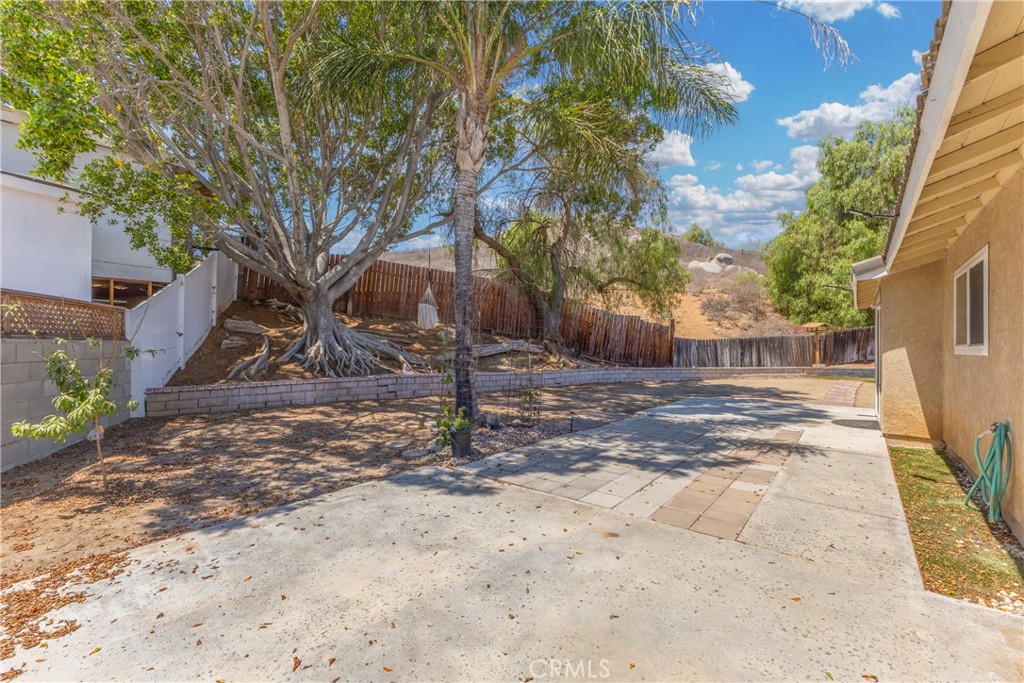 12011 Quantico Drive Riverside, CA 92505 - Photo 59 of 75 a view of a backyard that has a tree on the side