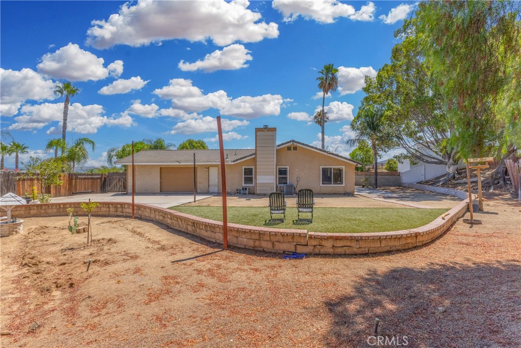 12011 Quantico Drive Riverside, CA 92505 - Photo 62 of 75 a view of a swimming pool with a yard
