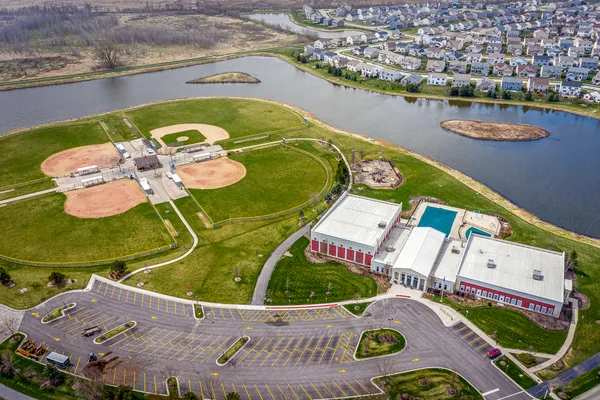 an aerial view of a house with a swimming pool outdoor seating and yard