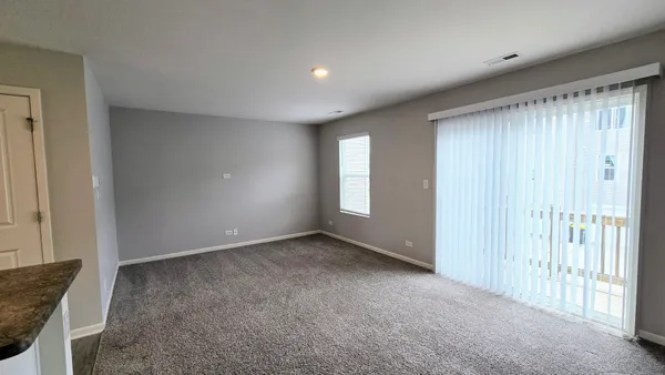 a view of an empty room and a window