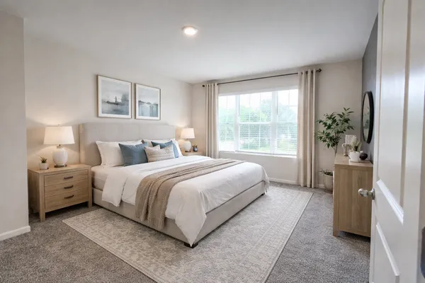 a spacious bedroom with a bed and a large window