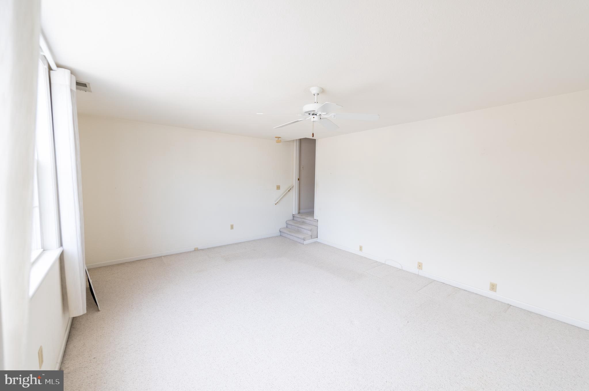 62 Hingham Lane Berlin, MD 21811 - Photo 20 of 44 an empty room with a ceiling fan and window