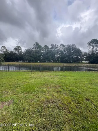 a view of outdoor space with swimming pool and green space