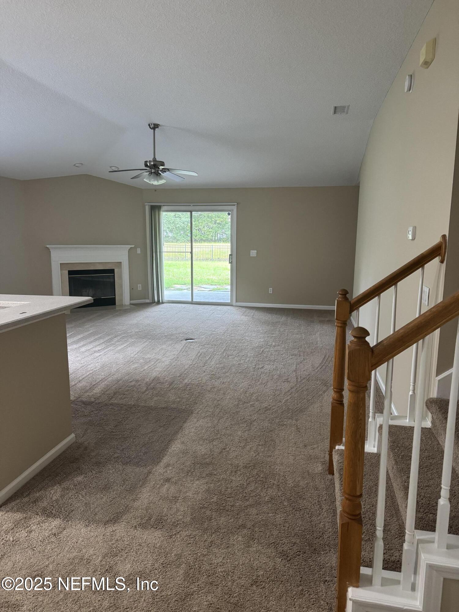 1428 Tintern Lane St. Augustine, FL 32092 - Photo 5 of 15 a view of an empty room with a window and fireplace