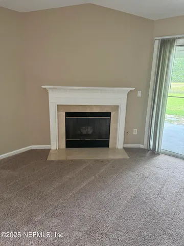 a view of empty room with a fireplace