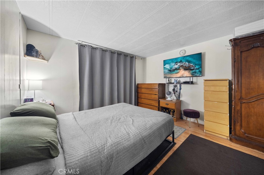 12401 Filmore Street, Unit 641 Sylmar, CA 91342 - Photo 16 of 24 a bedroom with a bed and a view of kitchen