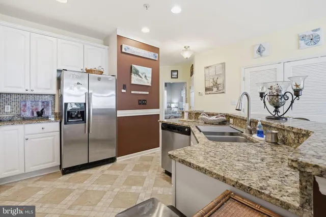 a hallway with painting on the wall and a window