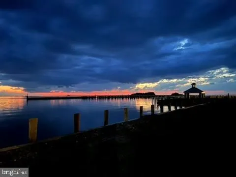 a spacious bedroom with a bed a couch and a chandelier