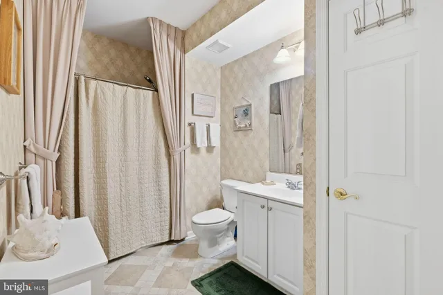 a view of a bathroom with a tub and shower