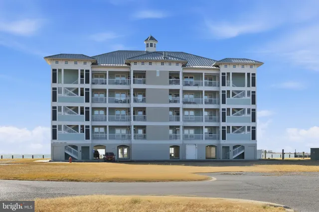 a terrace with a table and chairs under an umbrella