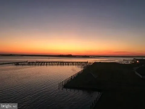 a view of a patio with table and chairs and potted plants