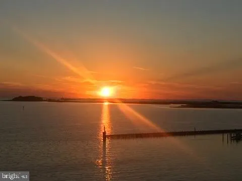 a view of a lake with houses in the back
