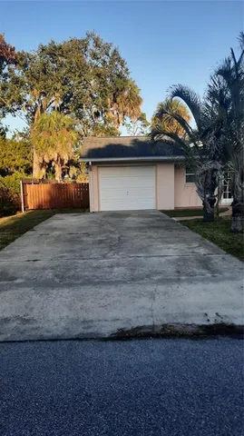 a view of house with backyard and glass windows