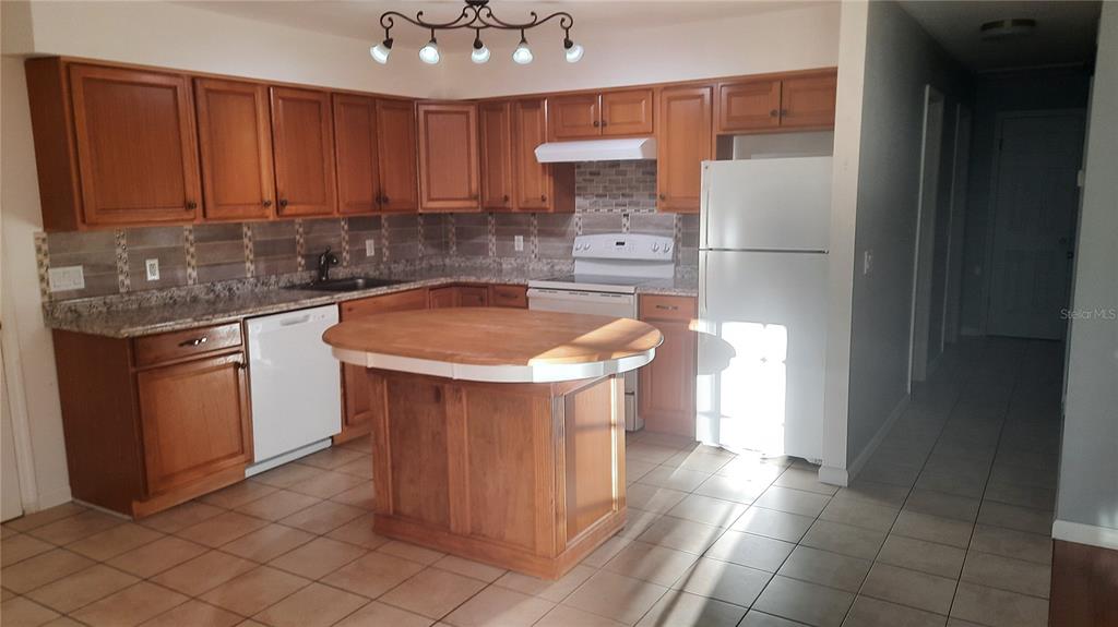 1333 Bender Avenue Holly Hill, FL 32117 - Photo 22 of 37 a kitchen with a sink and cabinets