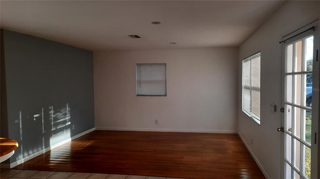 1333 Bender Avenue Holly Hill, FL 32117 - Photo 23 of 37 a view of an empty room with wooden floor and a window