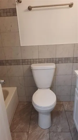 a bathroom with a toilet a sink and a shower