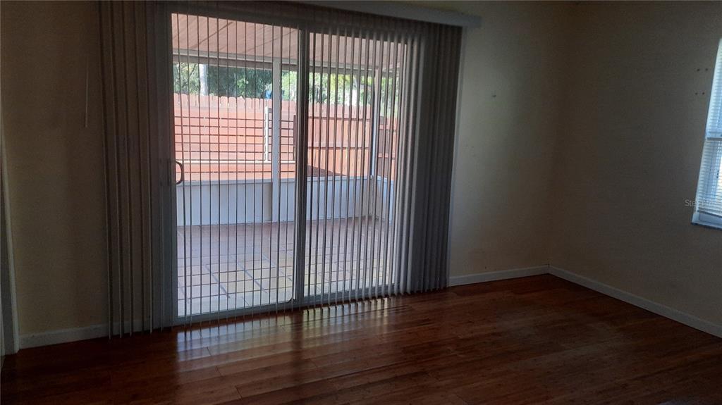 1333 Bender Avenue Holly Hill, FL 32117 - Photo 35 of 37 a view of an empty room with wooden floor and a window