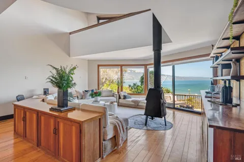 a kitchen with stainless steel appliances kitchen island granite countertop a table and chairs in it
