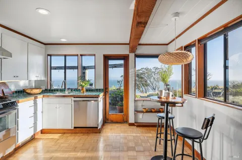 a bedroom with a bed and a dresser next to a window
