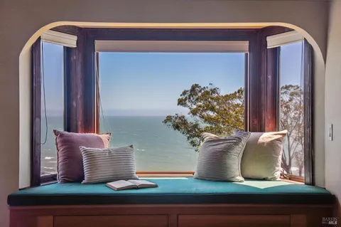 a view of a balcony with furniture and a floor to ceiling window