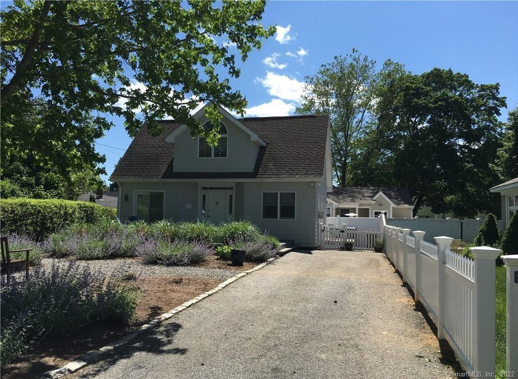 a front view of a house with yard and green space