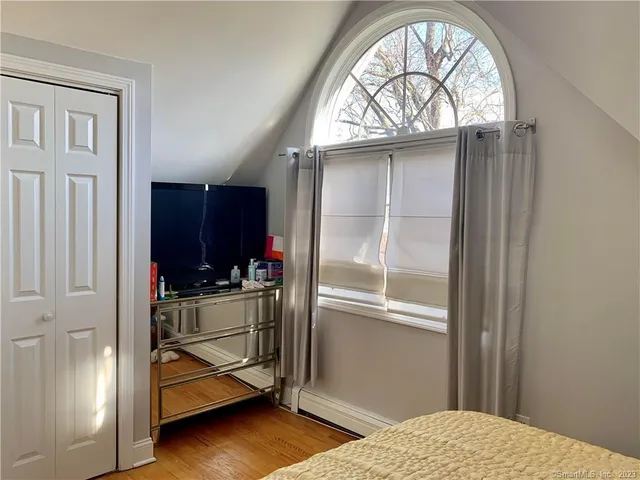 a bedroom with a bed and a window