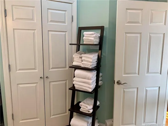 a view of hallway with stairs and furniture