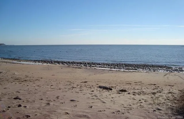a view of a dry field with wooden fence