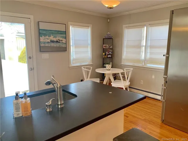 a view of a dining room with furniture and a window