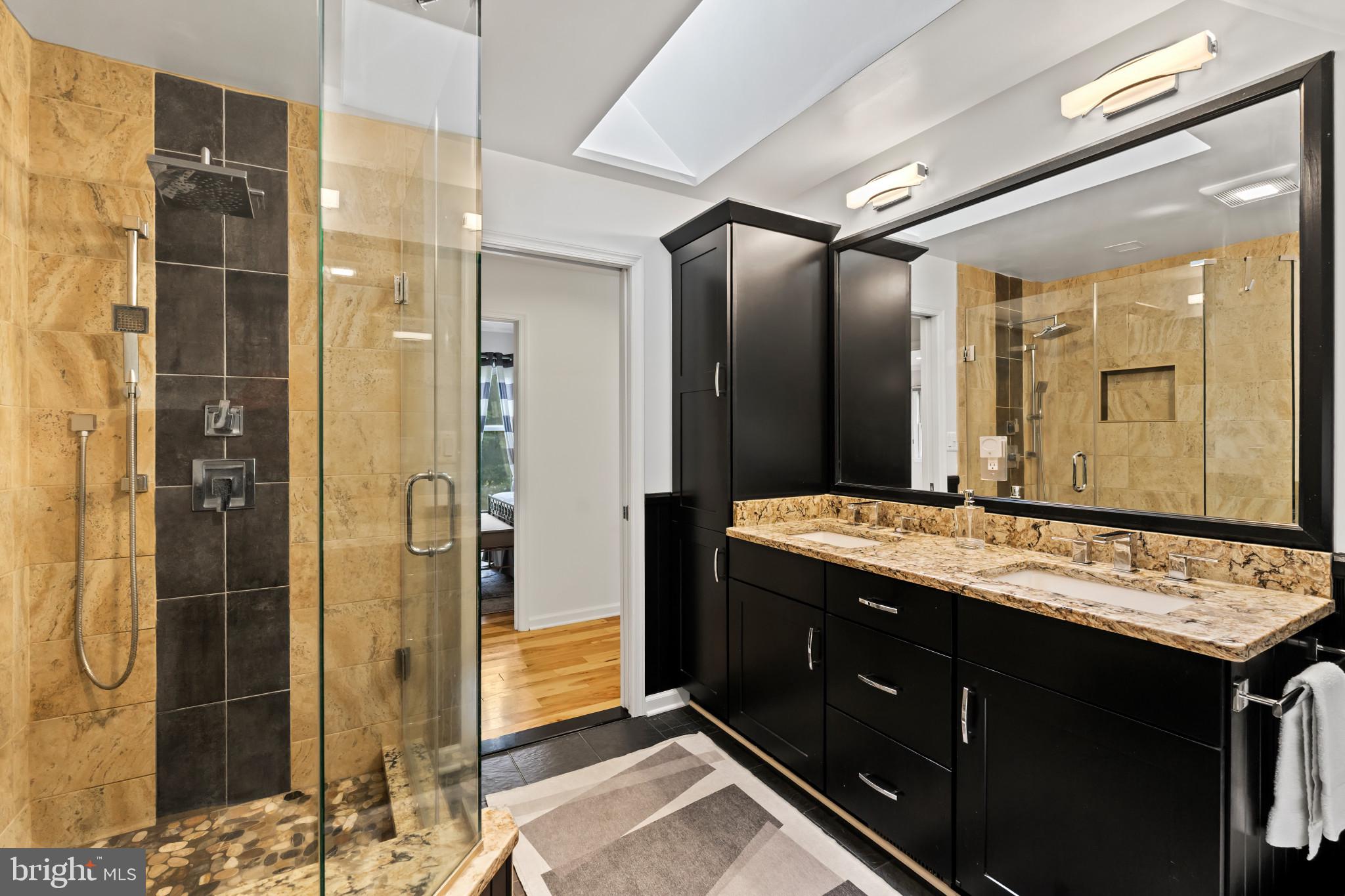 10821 Braeburn Road Columbia, MD 21044 - Photo 41 of 64 a bathroom with a granite countertop sink shower and a mirror