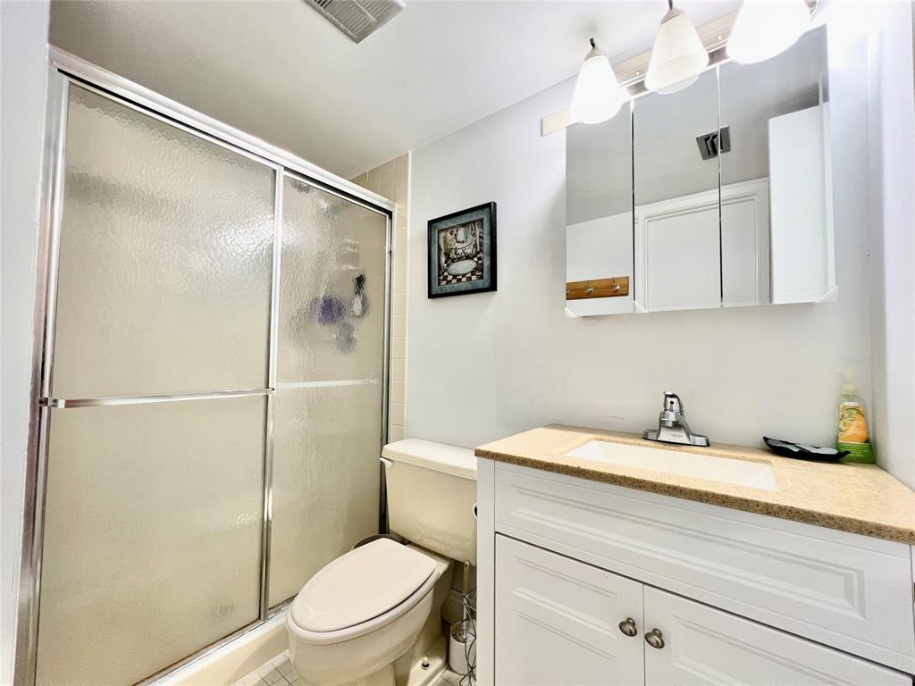7750 Northwest 79th Avenue, Unit H5 Tamarac, FL 33321 - Photo 13 of 28 a bathroom with a sink a toilet and shower