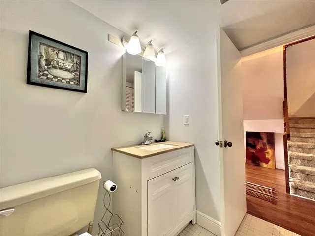 a bathroom with a toilet a sink and a mirror
