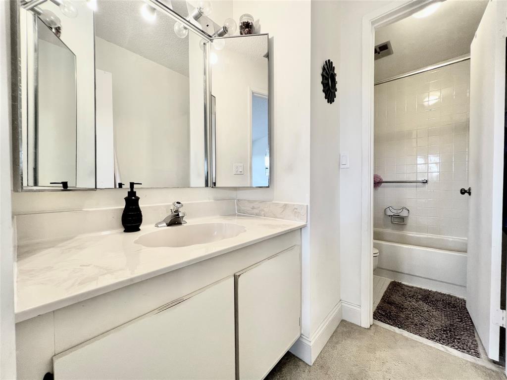7750 Northwest 79th Avenue, Unit H5 Tamarac, FL 33321 - Photo 20 of 28 a bathroom with a tub sink and mirror