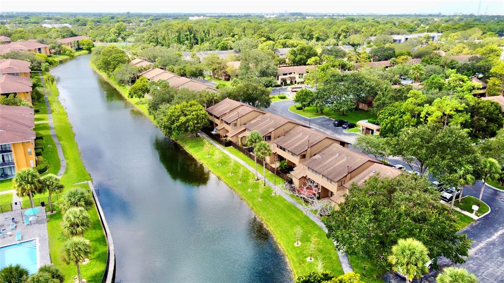 7750 Northwest 79th Avenue, Unit H5 Tamarac, FL 33321 - Photo 2 of 28 an aerial view of residential houses with outdoor space and swimming pool
