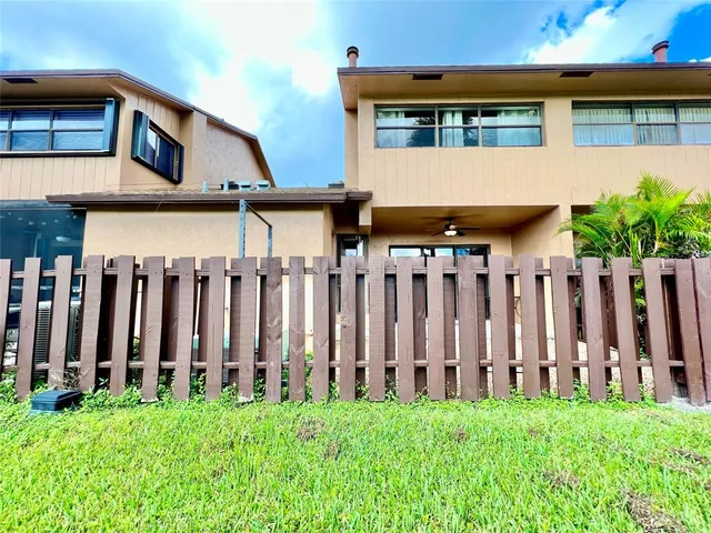 a view of a house with wooden fence