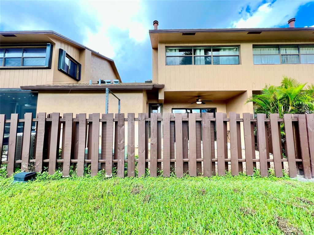 7750 Northwest 79th Avenue, Unit H5 Tamarac, FL 33321 - Photo 21 of 28 a view of a house with wooden fence