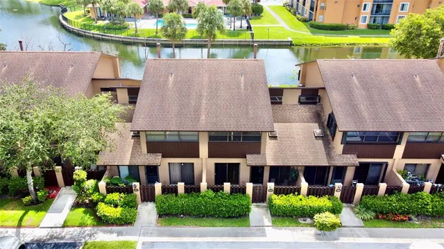 a aerial view of a house with a yard and potted plants