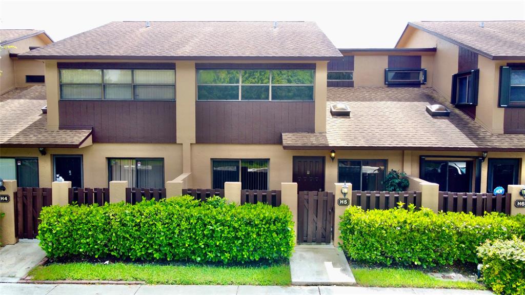 7750 Northwest 79th Avenue, Unit H5 Tamarac, FL 33321 - Photo 27 of 28 a front view of a house with garden