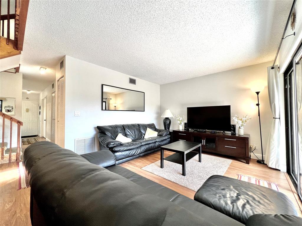 7750 Northwest 79th Avenue, Unit H5 Tamarac, FL 33321 - Photo 5 of 28 a living room with furniture and a flat screen tv