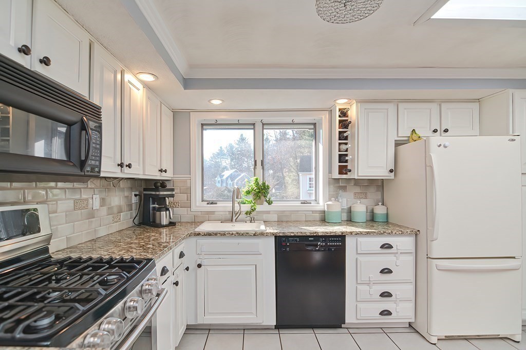 13 Parlee Road Chelmsford, MA 01824 - Photo 3 of 24 a kitchen with white cabinets and white appliances